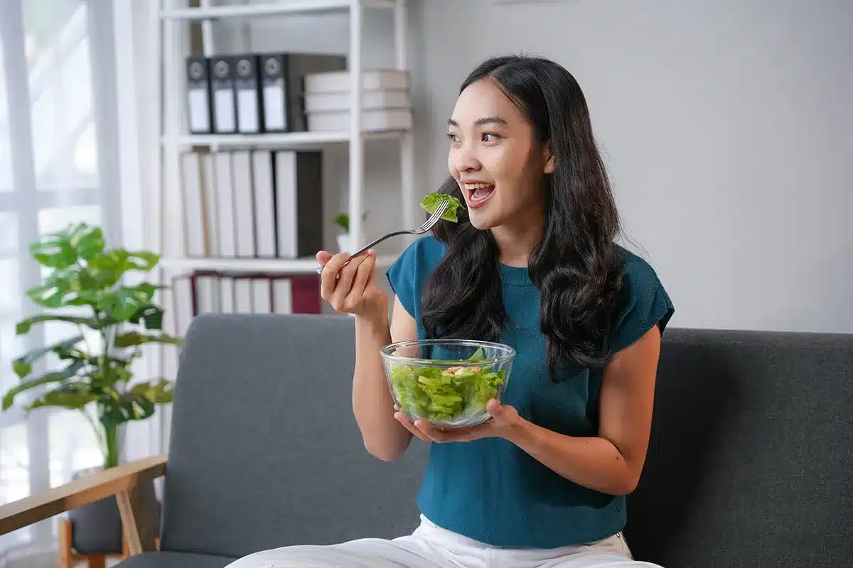 Woman enjoying a healthy salad.