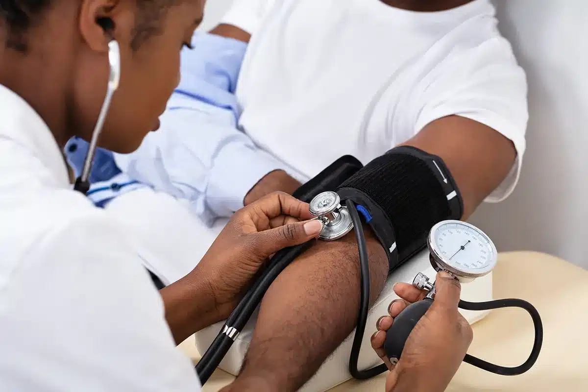 doctor measuring blood pressure of patient
