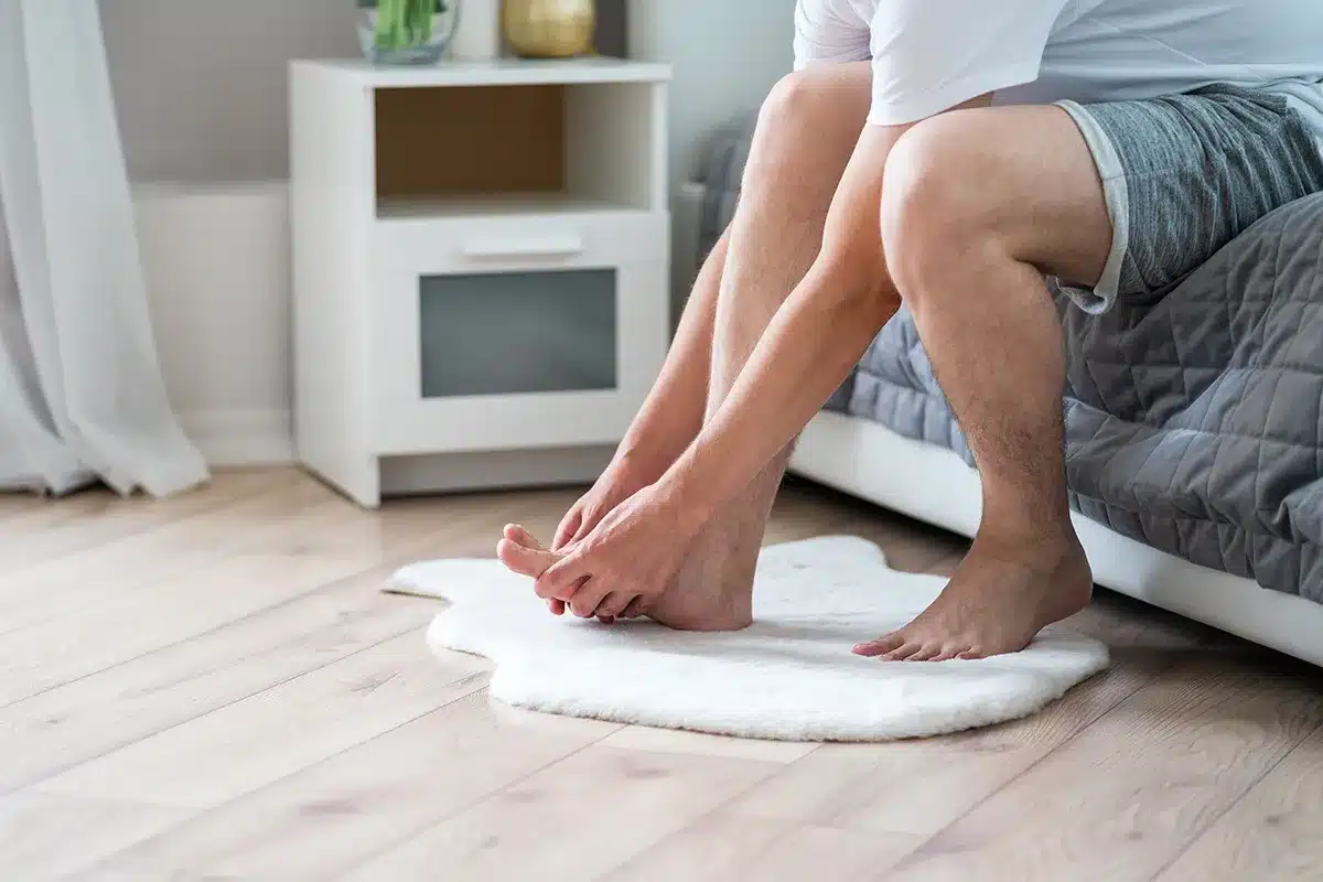 Man massaging his feet.