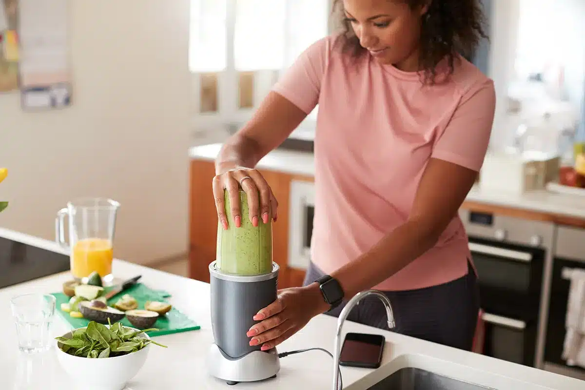woman making healthy juice drink