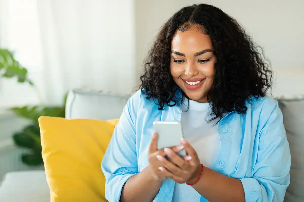 Plus-size woman using smartphone.