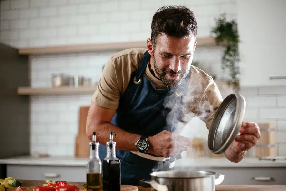 Man cooking healthy meal in kitchen.
