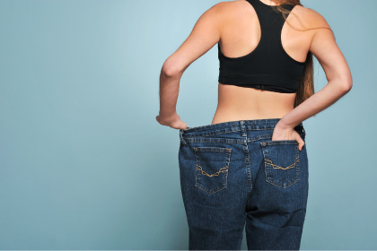 Women shows her weight loss scaled